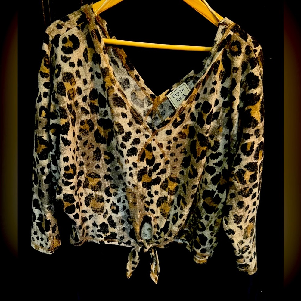 Double V animal print sweater with tie at waist.